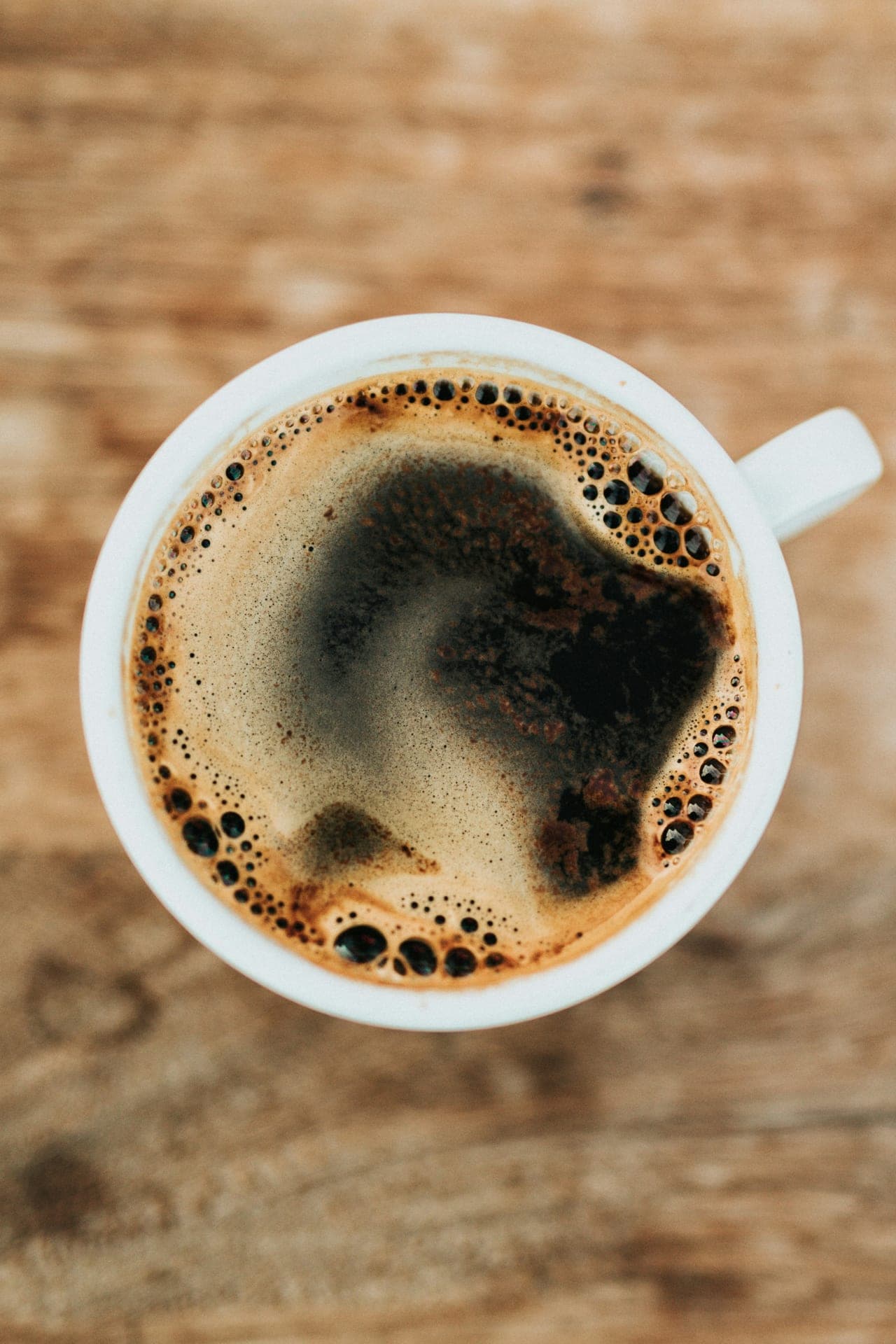 Black coffee with crema in a white mug