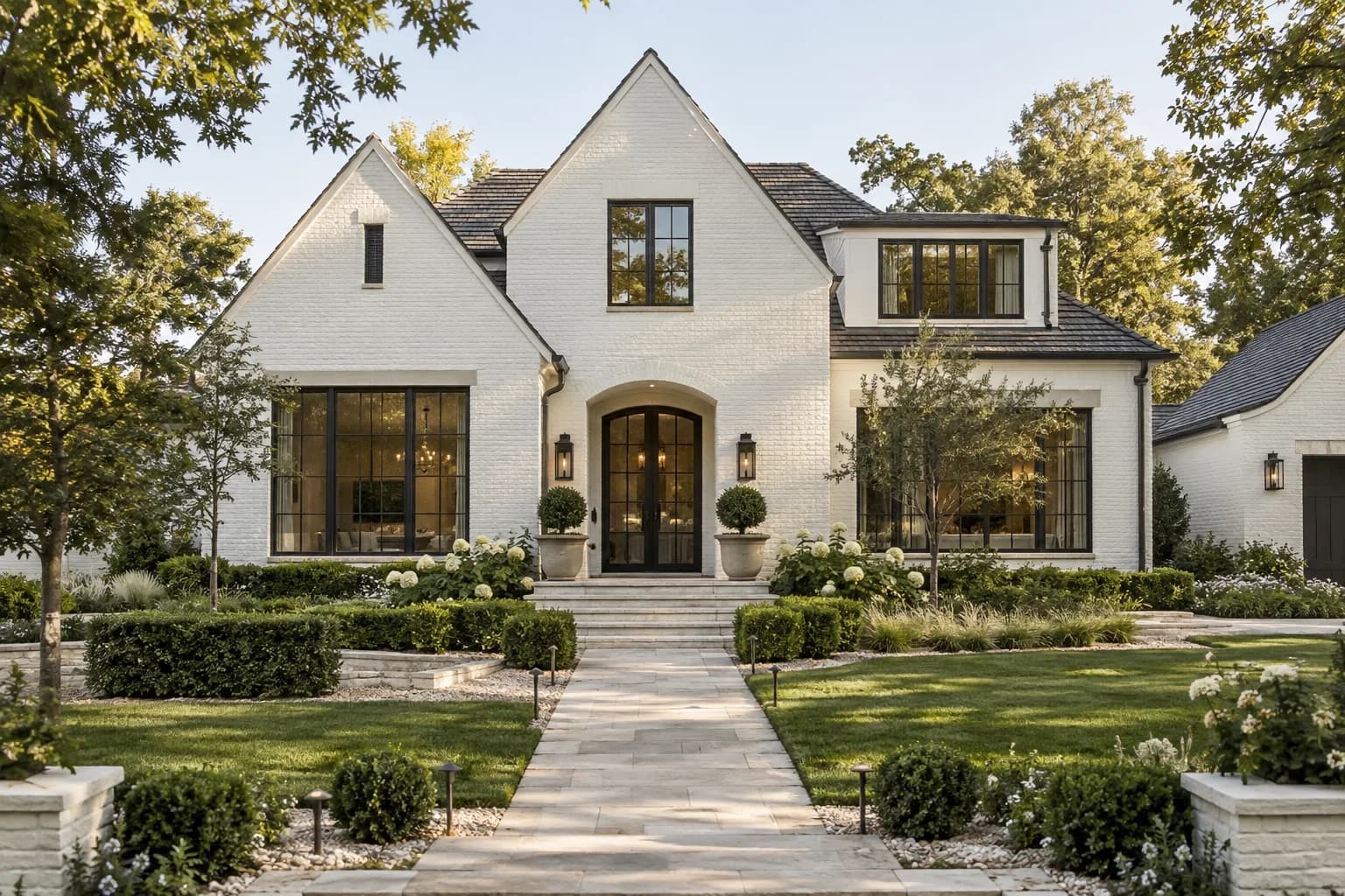 contemporary detached family house exterior, white brick, broad gables and landscaped front path